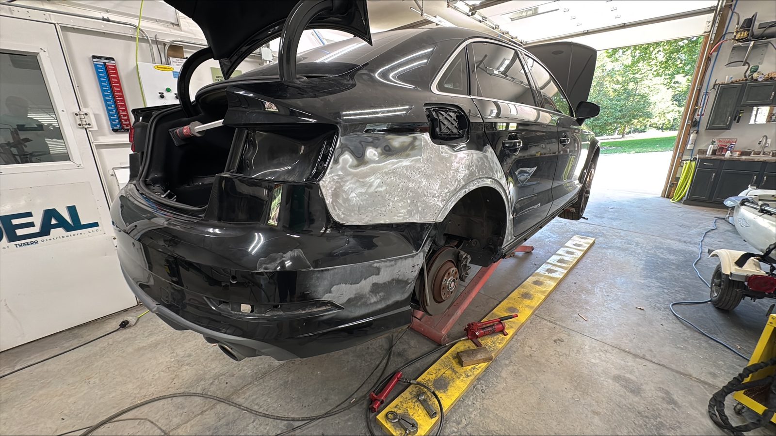 Audi rear quarter and bumper area during metal and panel work